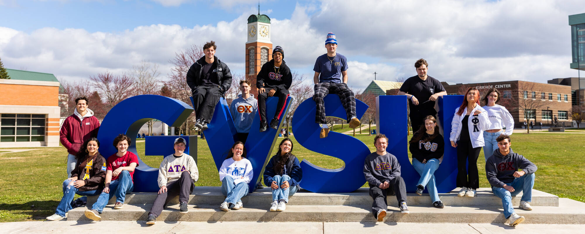 Students sitting on GVSU letters